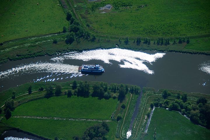 Lagoon cruise between meadows and dykes, aerial view