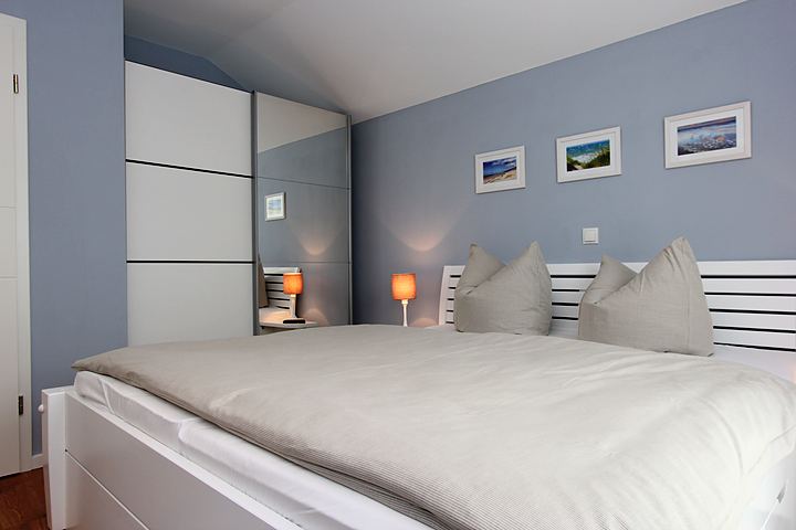 Bedroom with large double bed and wardrobe